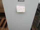a white refrigerator sitting on a pallet with a note pinned to it