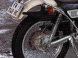 a motorcycle parked in a parking lot with a license plate on it
