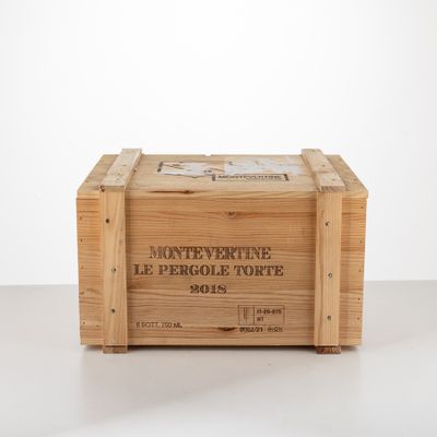 an old wooden box with a label on it sitting on a table