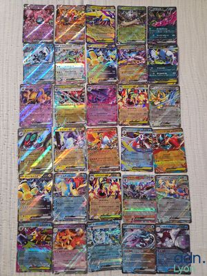 a pile of pokemon cards sitting on top of a table