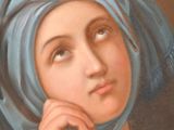 painting of a woman in a blue turban with her hand on her chin