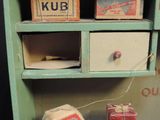a small cabinet with a bunch of boxes on top of it