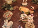 many figurines sitting on a table in a room