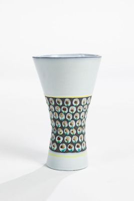 a white vase with a pattern on it on a white surface