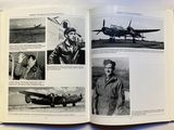 an open book with a picture of a man standing in front of a plane