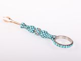 a close up of a turquoise and silver ring on a white surface