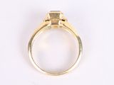 a close up of a gold ring with a diamond