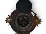 a clock that is on the wall with a hat on top of it