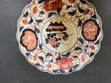a plate with a bird on it on a table