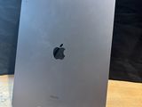 a close up of an apple ipad on a wooden table