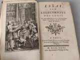 an old book with a picture of a group of people sitting at a table