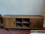 a wooden entertainment center in the corner of a living room