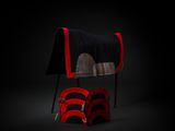 a black and red chair with a blanket on top of it