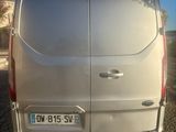 l'arrière d'une camionnette argentée garée sur un parking