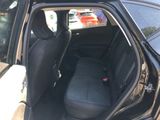 the back seat of a black car with the door open