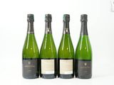 trois bouteilles de vin posées les unes à côté des autres sur une surface blanche