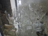 many empty wine glasses sitting on a glass table