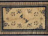 un tapis oriental orné de fleurs bleues et jaunes sur fond beige