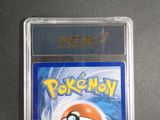 the pokemon card is in a clear plastic holder on a table