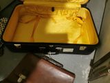 a brown suitcase with a brown bag inside of it