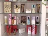 a display of cosmetics products on a shelf in a room