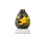yellow and black vase sitting on top of a white surface