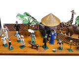 many figurines of people and animals on a table