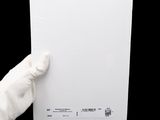 a person holding a piece of white paper in their hand