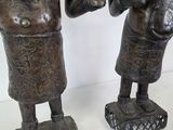 two statues of a man and a woman standing next to each other
