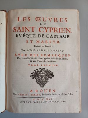 an old book that is open on a table