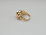 a gold ring with a diamond on top of it