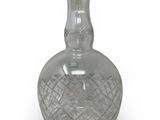 a clear glass bottle with a stopper on top of it