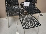 three black chairs with a price tag on them sitting on a floor