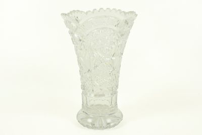 a glass vase that is sitting on a white surface