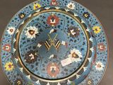 an image of a blue and yellow plate with a clock on it