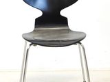a black chair with a metal frame and a black seat