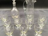 a lot of wine glasses and a pitcher on a table