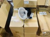 a lot of boxes and a fan in the middle of the room