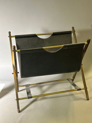 a black and gold magazine rack with a magazine holder