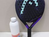 a tennis racket and a bottle of water on a table