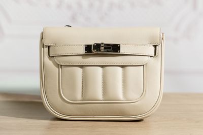 un petit sac à main blanc posé sur une table en bois