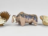 three figurines of animals that are standing next to each other