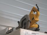 a circular saw on top of a box on a shelf