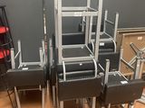 four black leather chairs are stacked on top of each other in a room