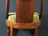 an image of a wooden chair with a green cushion on top of it