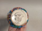 a person holding a coin in their hand on a table