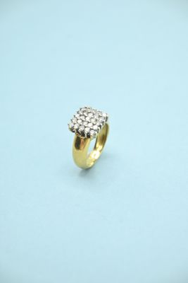 a close up of a gold ring with diamonds on a blue surface