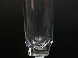 a wine glass sitting on a table with a black background