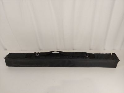 a black bag with a handle on it sitting on a white surface