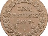a close up of a coin with a wreath on it